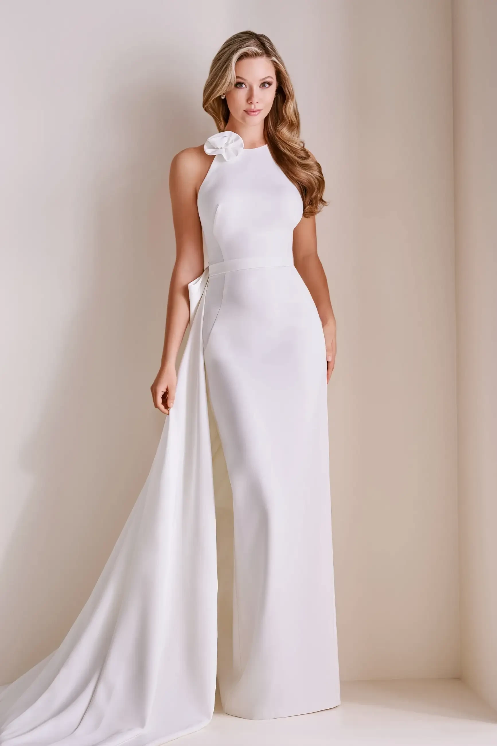 model is wearing a high neckline sleeveless sheath wedding dress