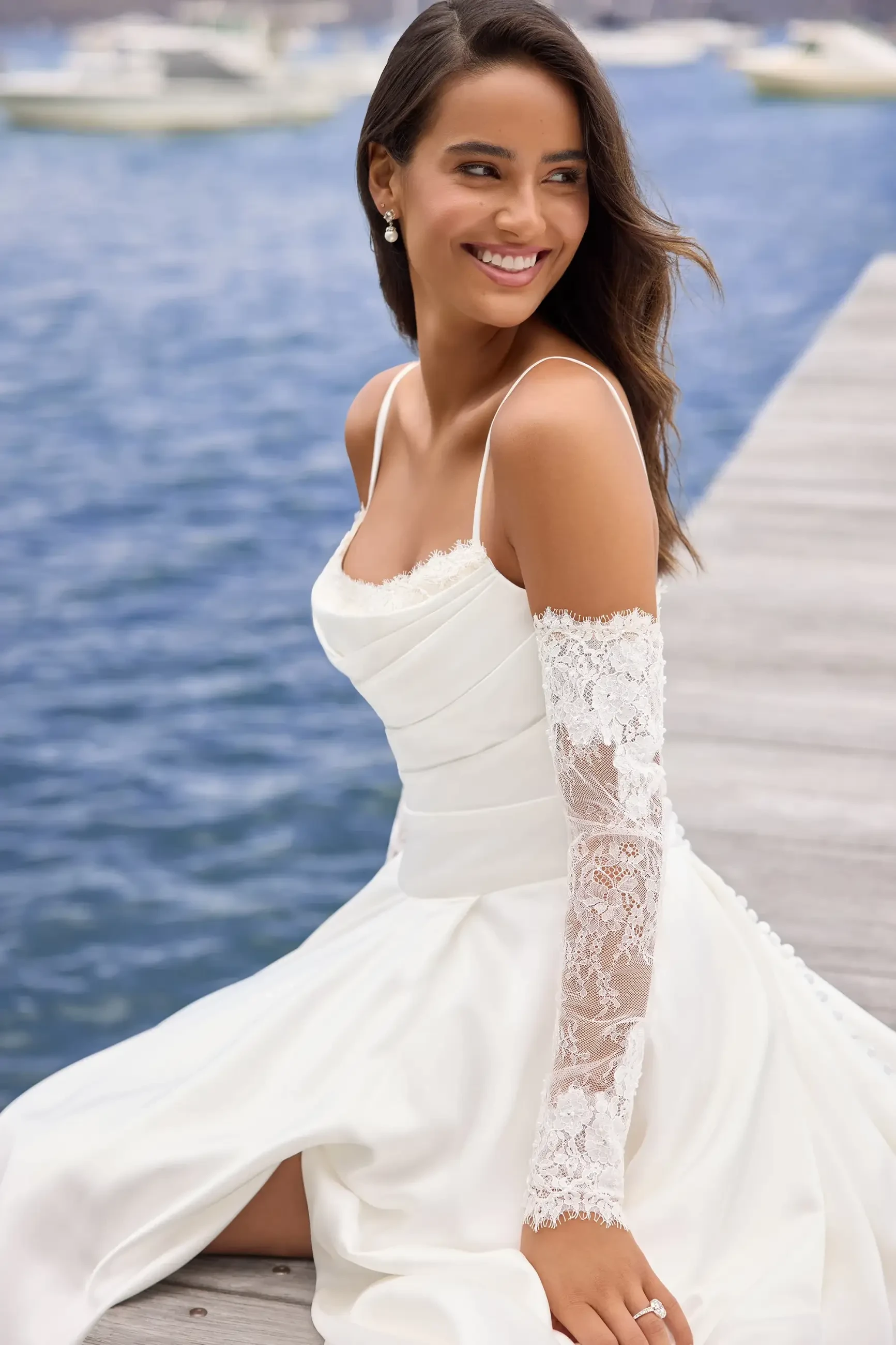 model is wearing an off the shoulder a-line wedding dress by sophia tolli