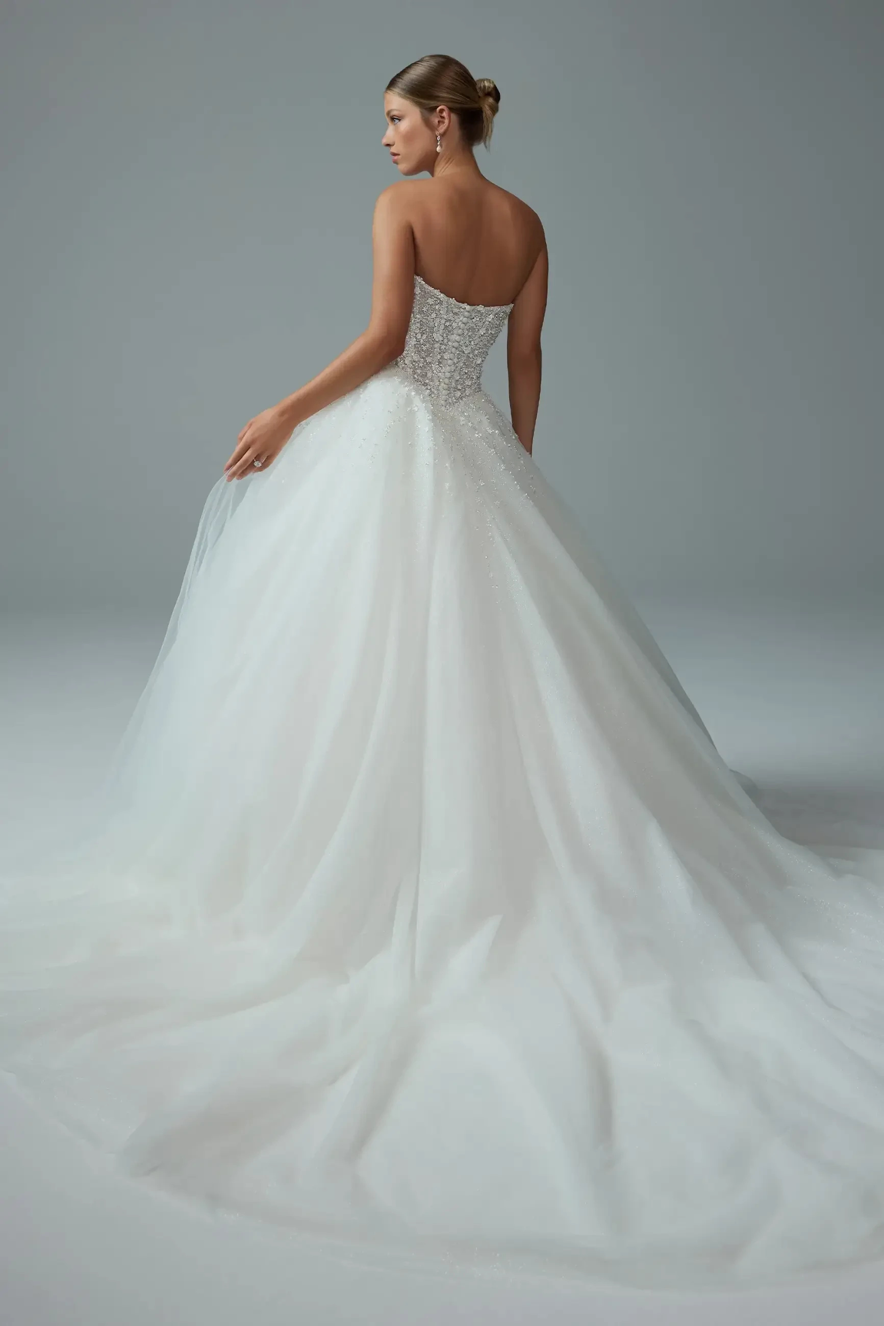 model is wearing a strapless a-line wedding dress by sophia tolli 