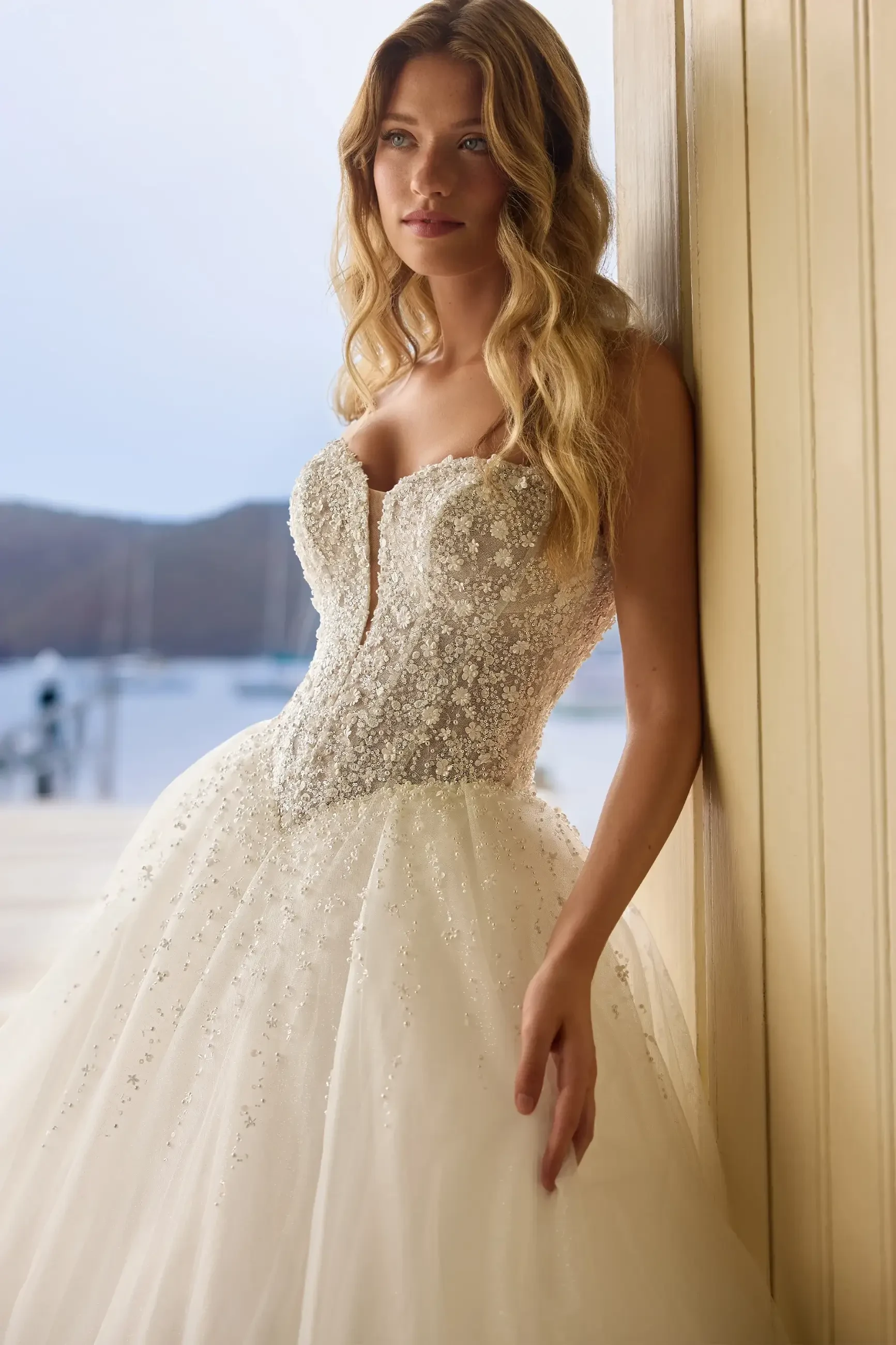 model is wearing a strapless a-line wedding dress by sophia tolli 